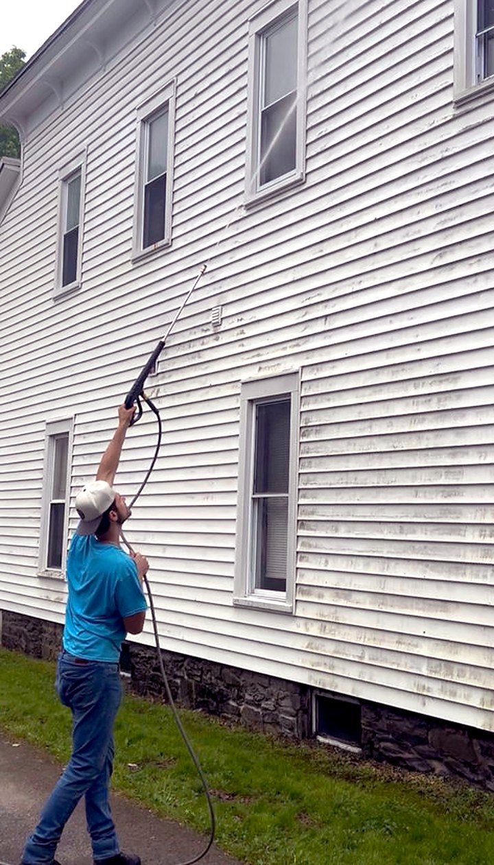 Hunter Williams pressure washing a home in Central New York